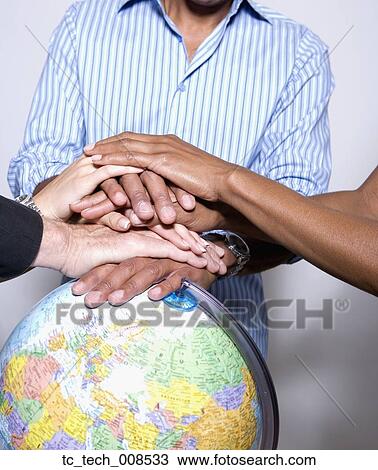 Multi-ethnic businesspeople with hands on globe View Large Photo Image Stock Image - Multi-ethnic businesspeople with hands on globe. Fotosearch
