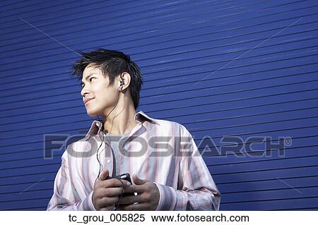 Pacific Islander man listening to mp3 player View Large Photo Image Stock Photography - Pacific Islander man listening to mp3 player. Fotosearch