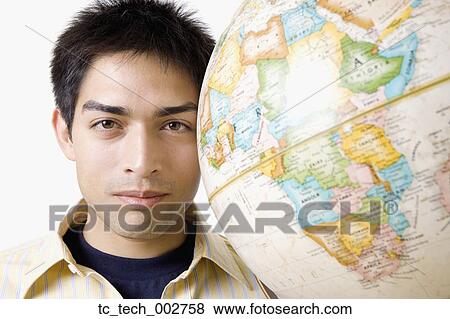 Stock Photo - Pacific Islander man next to globe. Fotosearch