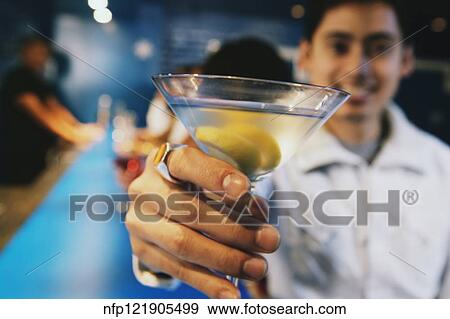 Pacific Islander man toasting with cocktail at bar View Large Photo Image Stock Photo - Pacific Islander man toasting with cocktail at bar. Fotosearch