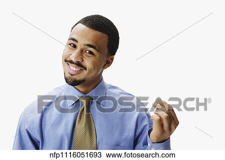 Portrait of African businessman rubbing fingers together View Large Photo Image Stock Image - Portrait of African businessman rubbing fingers together. Fotosearch