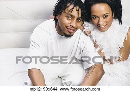 Picture - Portrait of African couple on sofa. Fotosearch