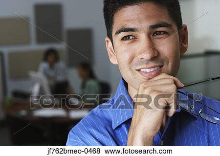 Portrait of Asian businessman holding eyeglasses View Large Photo Image Stock Photo - Portrait of Asian businessman holding eyeglasses. Fotosearch