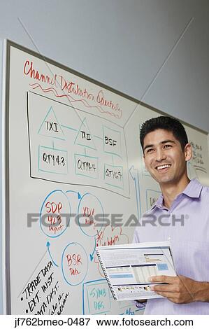 Stock Photo - Portrait of Asian businessman next to whiteboard. Fotosearch
