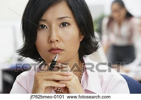 Portrait of Asian businesswoman holding pen View Large Photo Image Stock Image - Portrait of Asian businesswoman holding pen. Fotosearch
