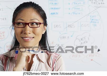 Portrait of Asian businesswoman in front of whiteboard View Large Photo Image Stock Photo - Portrait of Asian businesswoman in front of whiteboard. Fotosearch