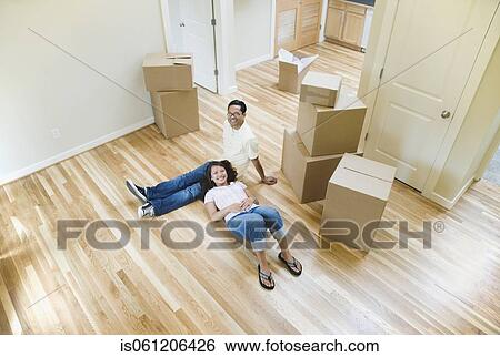 Stock Photograph - Portrait of Asian couple in new house . Fotosearch