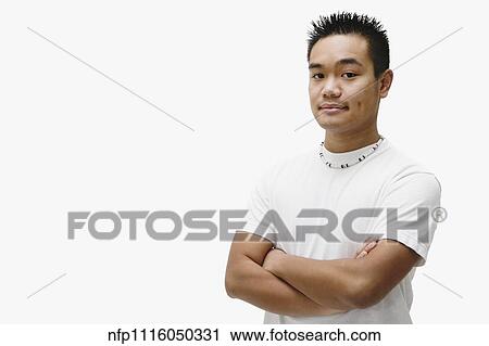 Stock Image - Portrait of Asian man with arms crossed. Fotosearch