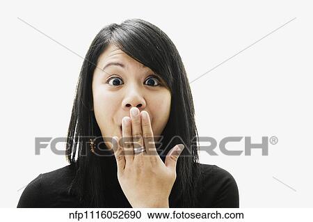 Stock Image - Portrait of Asian woman looking surprised. Fotosearch