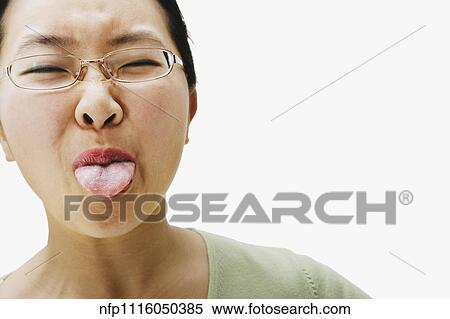 Portrait of Asian woman sticking out tongue View Large Photo Image Stock Photography - Portrait of Asian woman sticking out tongue. Fotosearch