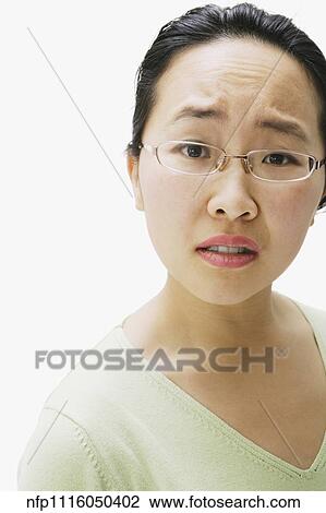 Portrait of Asian woman with brow furrowed View Large Photo Image Stock Image - Portrait of Asian woman with brow furrowed. Fotosearch