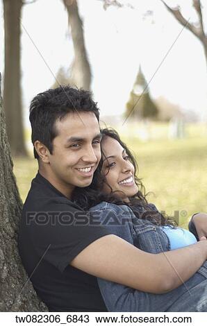 Portrait of couple leaning against tree View Large Photo Image Stock Image - Portrait of couple leaning against tree. Fotosearch
