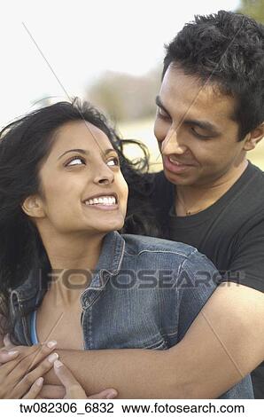 Portrait of couple smiling at each other View Large Photo Image Stock Image - Portrait of couple smiling at each other. Fotosearch
