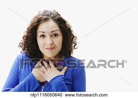 Portrait of woman holding hands over chest View Large Photo Image Stock Image - Portrait of woman holding hands over chest. Fotosearch