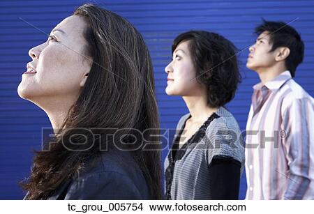 Picture - Profile of three Asian people looking up. Fotosearch