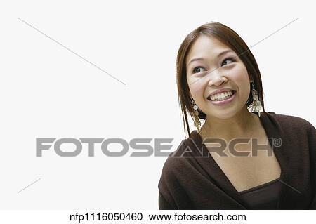 Stock Image - Studio shot of Asian woman smiling. Fotosearch