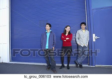Three friends standing on sidewalk View Large Photo Image Stock Image - Three friends standing on sidewalk. Fotosearch
