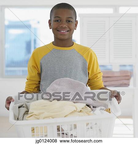 African boy carrying full laundry basket View Large Photo Image Stock Photo - African boy carrying full laundry basket. Fotosearch