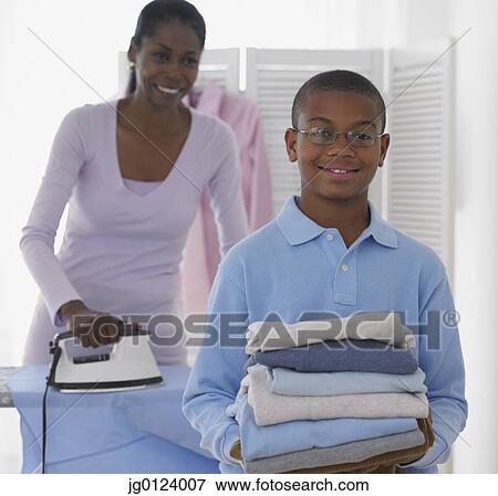 African boy helping mother with laundry View Large Photo Image Stock Photo - African boy helping mother with laundry. Fotosearch