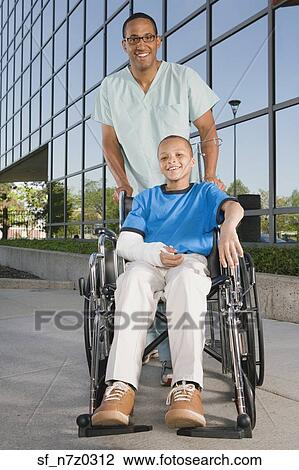 African boy in wheelchair with nurse in front of hospital View Large Photo Image Stock Image - African boy in wheelchair with nurse in front of hospital. Fotosearch