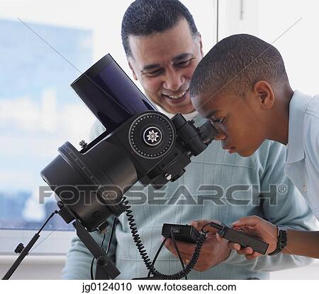 African boy looking into microscope with father View Large Photo Image Stock Image - African boy looking into microscope with father. Fotosearch