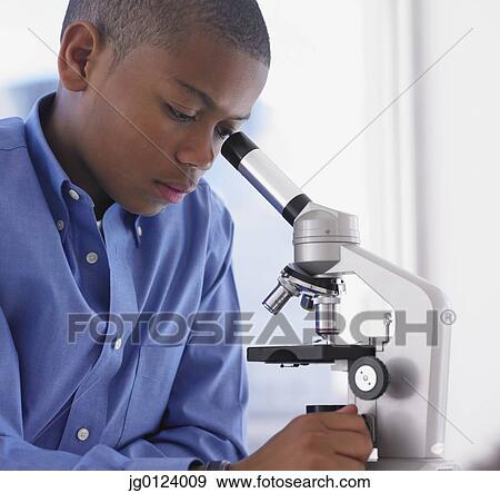 African boy looking into microscope View Large Photo Image Stock Photo - African boy looking into microscope. Fotosearch