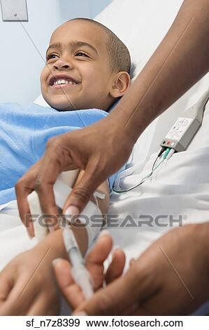 African boy receiving IV medication in hospital bed View Large Photo Image Stock Photo - African boy receiving IV medication in hospital bed. Fotosearch