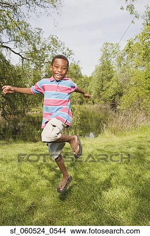 African boy running and jumping in park View Large Photo Image Picture - African boy running and jumping in park. Fotosearch