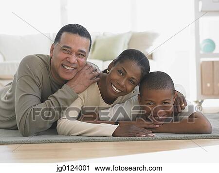 African family laying on livingroom rug smiling View Large Photo Image Stock Image - African family laying on livingroom rug smiling. Fotosearch