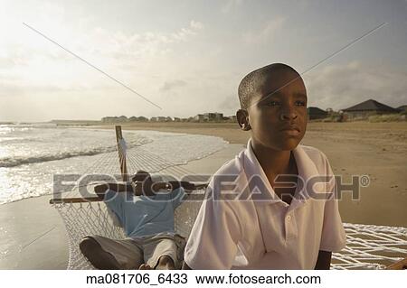 African father and son in hammock at beach View Large Photo Image Stock Image - African father and son in hammock at beach. Fotosearch