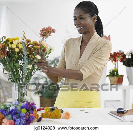 African female florist arranging flowers in shop View Large Photo Image Stock Photo - African female florist arranging flowers in shop. Fotosearch
