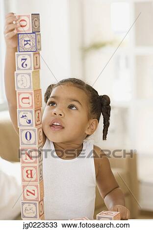 African girl building tower of blocks View Large Photo Image Stock Image - African girl building tower of blocks. Fotosearch