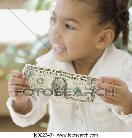 African girl holding dollar bill View Large Photo Image Stock Photo - African girl holding dollar bill. Fotosearch