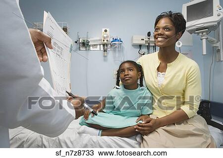 African girl in hospital bed with mother talking to doctor View Large Photo Image Stock Image - African girl in hospital bed with mother talking to doctor. Fotosearch