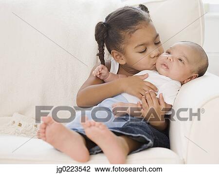 African girl kissing baby sibling View Large Photo Image Stock Image - African girl kissing baby sibling. Fotosearch