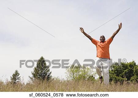African man running in field with arms outstretched View Large Photo Image Stock Photo - African man running in field with arms outstretched. Fotosearch