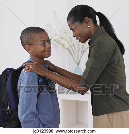 Stock Photo - African mother seeing son off the school. Fotosearch