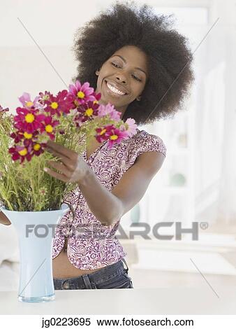 African woman arranging flowers View Large Photo Image Stock Photography - African woman arranging flowers. Fotosearch