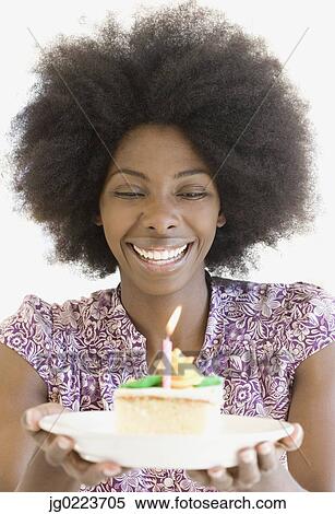 African woman holding piece of cake View Large Photo Image Stock Photography - African woman holding piece of cake. Fotosearch