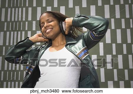 African woman listening to music on headphones View Large Photo Image Stock Image - African woman listening to music on headphones. Fotosearch