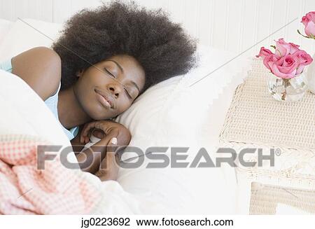 Stock Image - African woman sleeping. Fotosearch