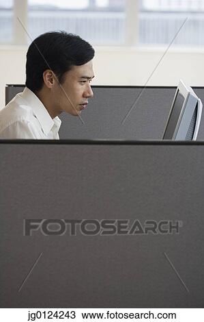 Asian businessman working in cubicle View Large Photo Image Stock Image - Asian businessman working in cubicle. Fotosearch