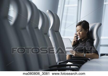 Asian businesswoman using cell phone in conference room View Large Photo Image Stock Image - Asian businesswoman using cell phone in conference room. Fotosearch
