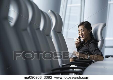 Asian businesswoman using cell phone in conference room View Large Photo Image Stock Image - Asian businesswoman using cell phone in conference room. Fotosearch