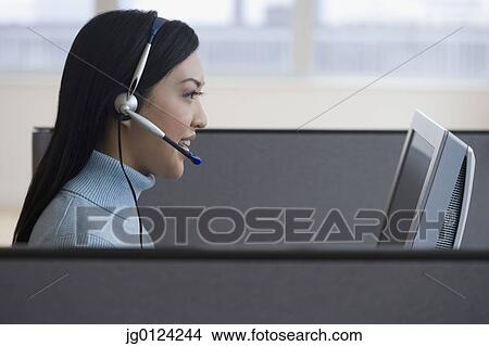 Asian businesswoman working in cubicle View Large Photo Image Picture - Asian businesswoman working in cubicle. Fotosearch