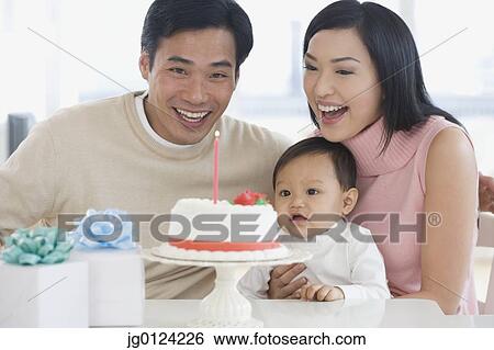 Asian family celebrating baby's first birthday View Large Photo Image Stock Photograph - Asian family celebrating baby's first birthday. Fotosearch