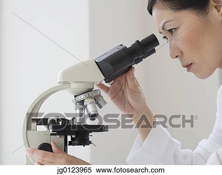 Asian female scientist looking into microscope View Large Photo Image Stock Photography - Asian female scientist looking into microscope. Fotosearch