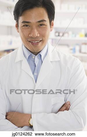 Asian male pharmacist standing in pharmacy View Large Photo Image Stock Image - Asian male pharmacist standing in pharmacy. Fotosearch