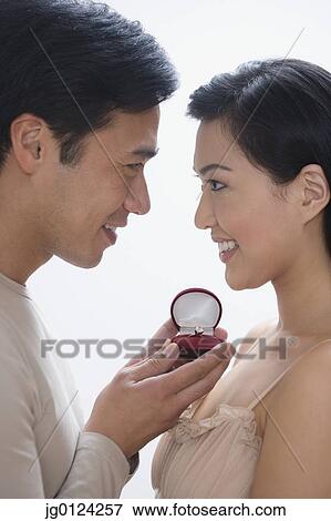 Asian man proposing to girlfriend View Large Photo Image Stock Photo - Asian man proposing to girlfriend. Fotosearch