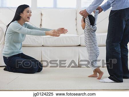 Asian parents helping baby walk View Large Photo Image Stock Photography - Asian parents helping baby walk. Fotosearch